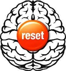 Illustration of a brain viewed from above with a large orange reset button at its centre
