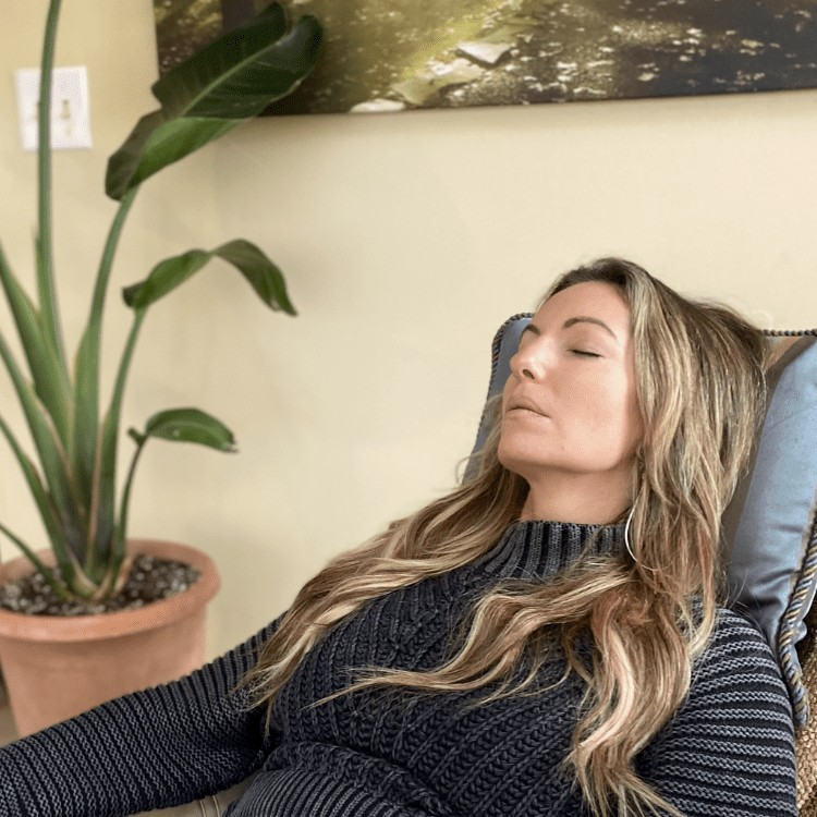 Kristin Shelly resting in hypnosis in a recliner